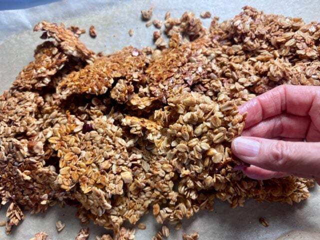 crunchy homemade granola clusters close up on baking sheet