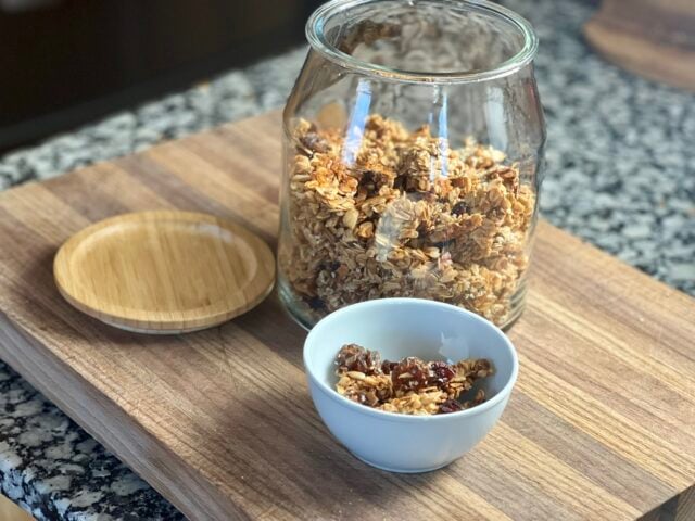 homemade granola in glass jar and in white ceramic bowl