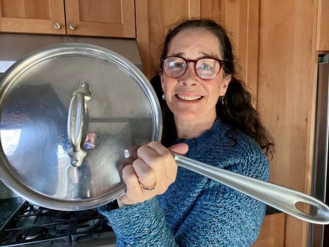 Mindful Momma holding All Clad stainless steel pan