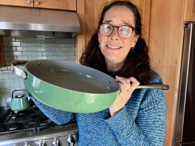 Mindful Momma holding Caraway ceramic non-stick cookware pan