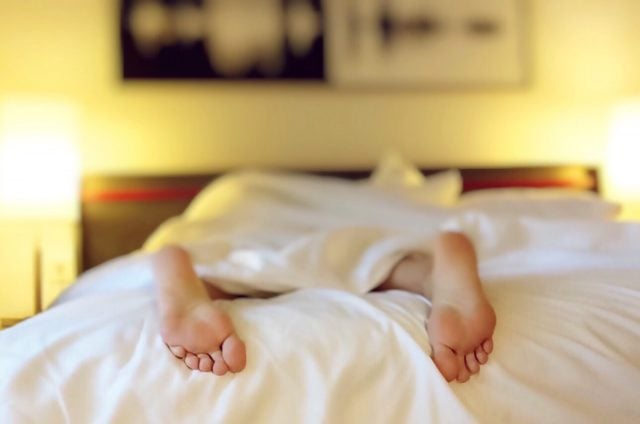 Person laying down on an organic mattress in a bedroom