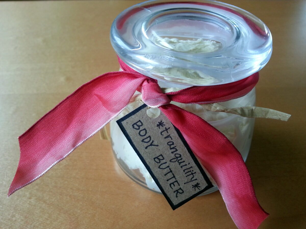 homemade body butter in jar with pink ribbon