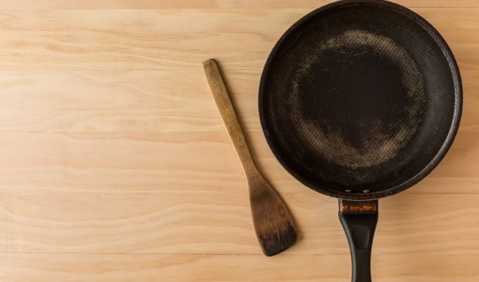 scratched cooking pan with PFAS chemicals