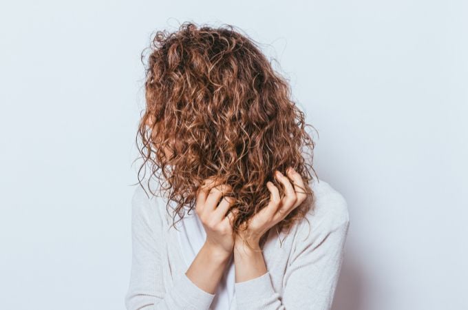 woman scrunching curly hair