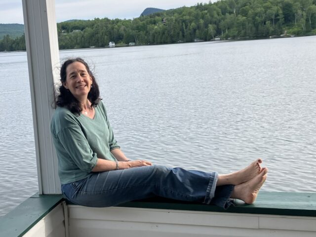 pact organic green top on woman at lake